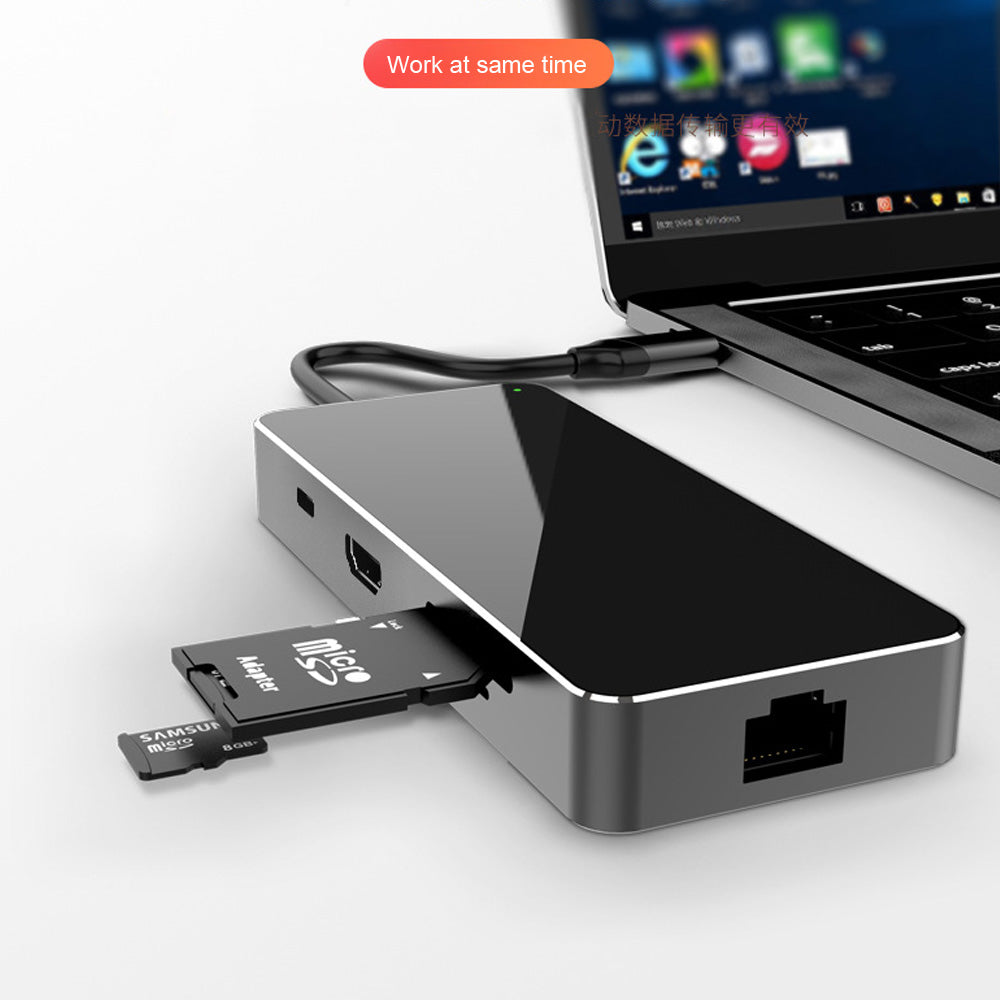 multi-function type c converter connected to a laptop with an SD card inserted, showcasing its functionality.